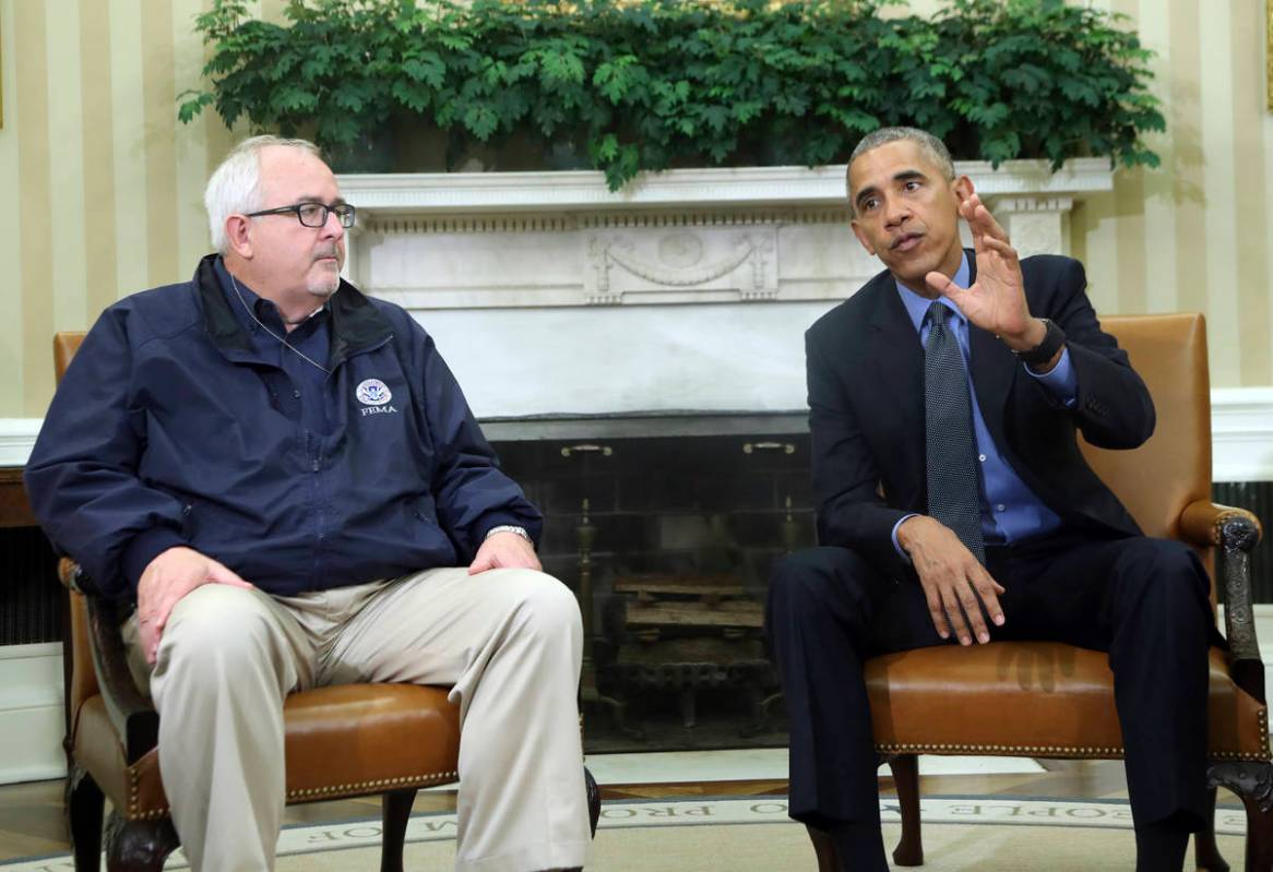 FILE - In this Oct. 7, 2016, file photo, President Barack Obama with FEMA Administrator Craig F ...