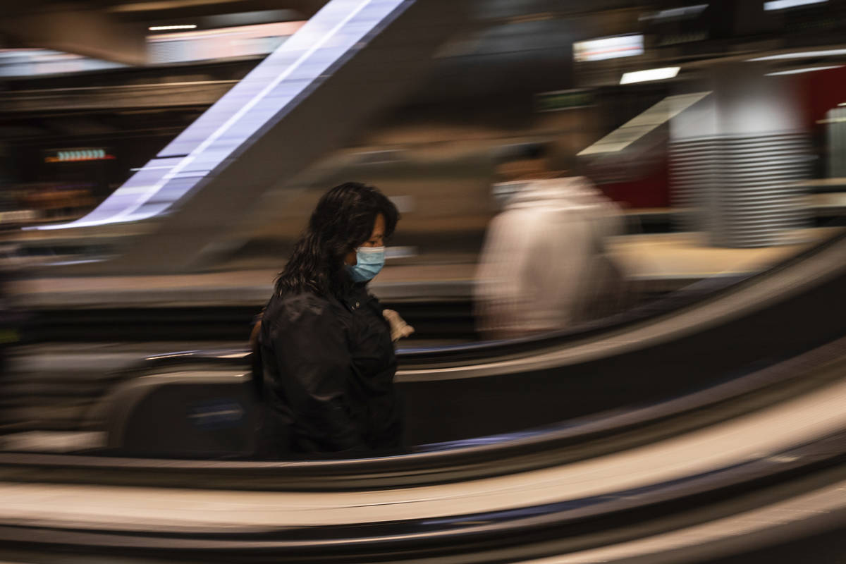 A commuter wearing a face mask to protect against coronavirus at Atocha train station in Madrid ...