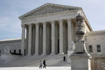 In this March 16, 2020 photo, people walk outside the Supreme Court in Washington. (AP Photo/P ...