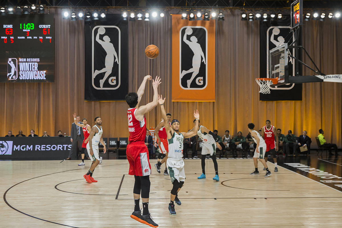 Memphis Hustle forward Yuta Watanabe (12) shoots a three point shot over Wisconsin Herd guard J ...