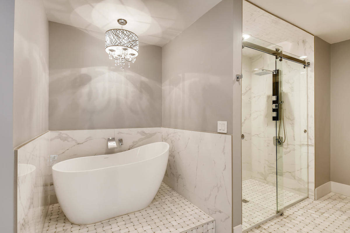 The spa-style bath has a freestanding bathtub and raised sinks. (BHHS)