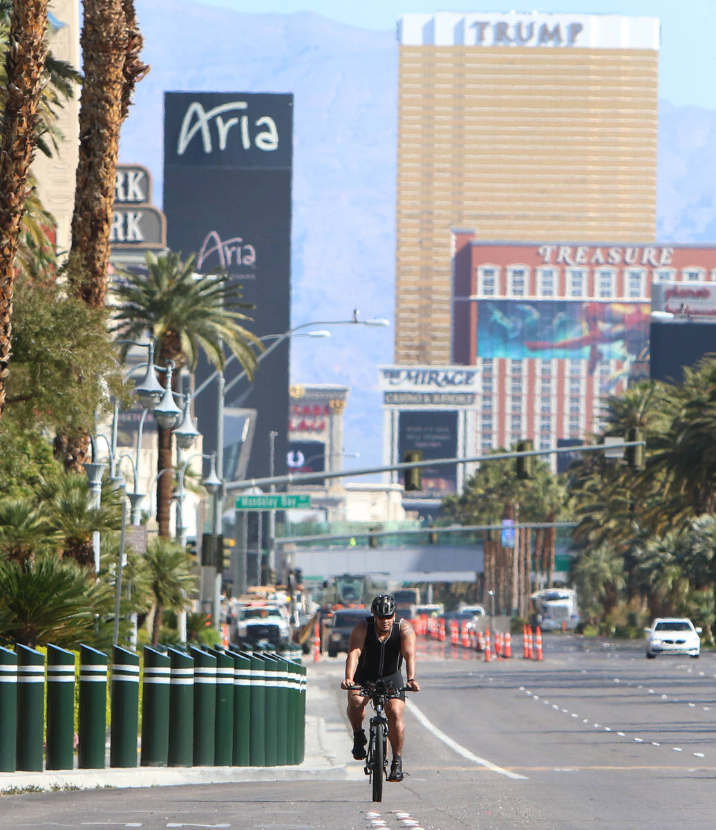 A man rides his bike along Las Vegas Boulevard during a sunny Tuesday, April 14, 2020, in Las V ...