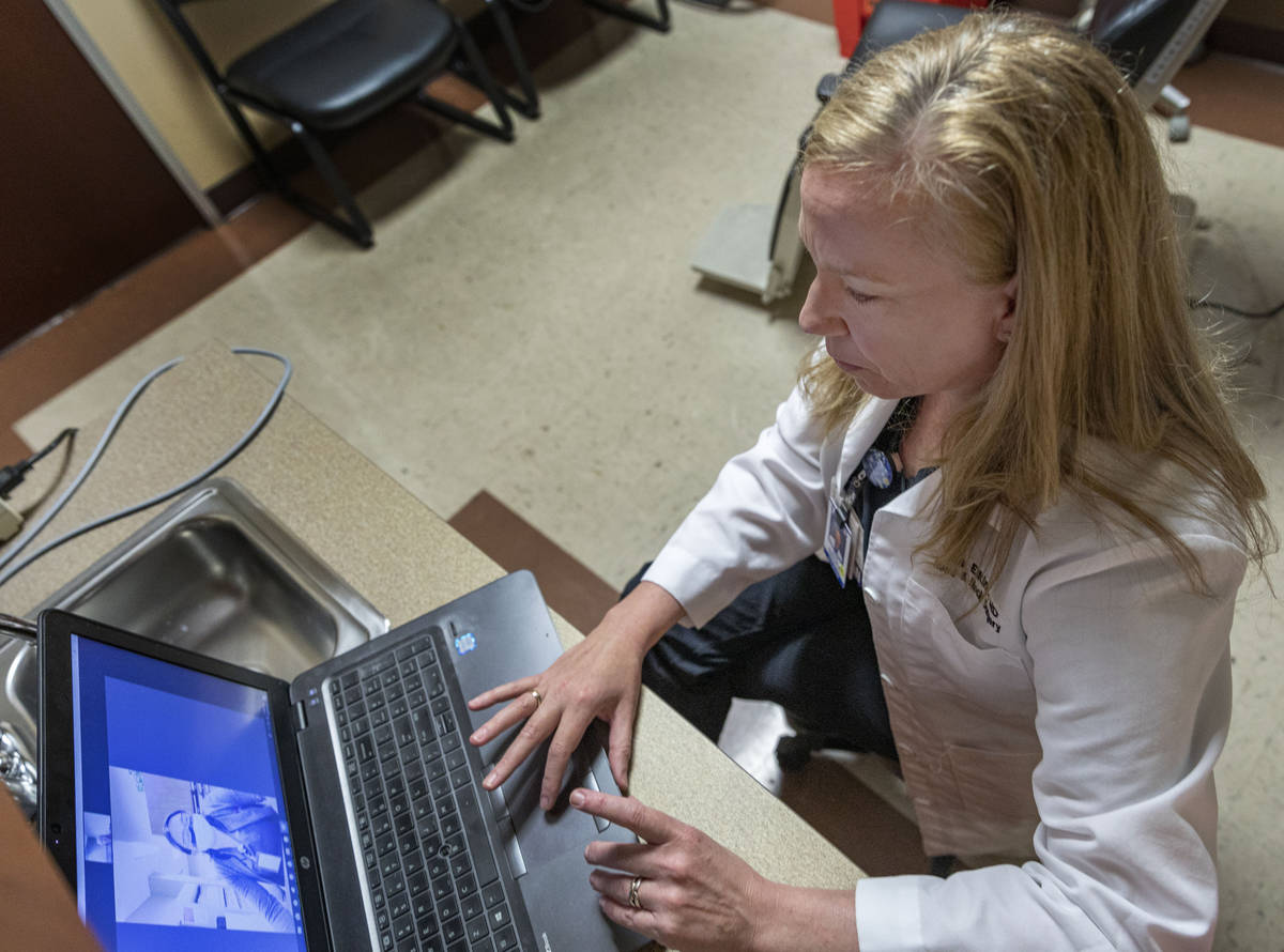 Dr. Tina Elkins, assistant professor of general otolaryngology at UNLV School of Medicine, demo ...