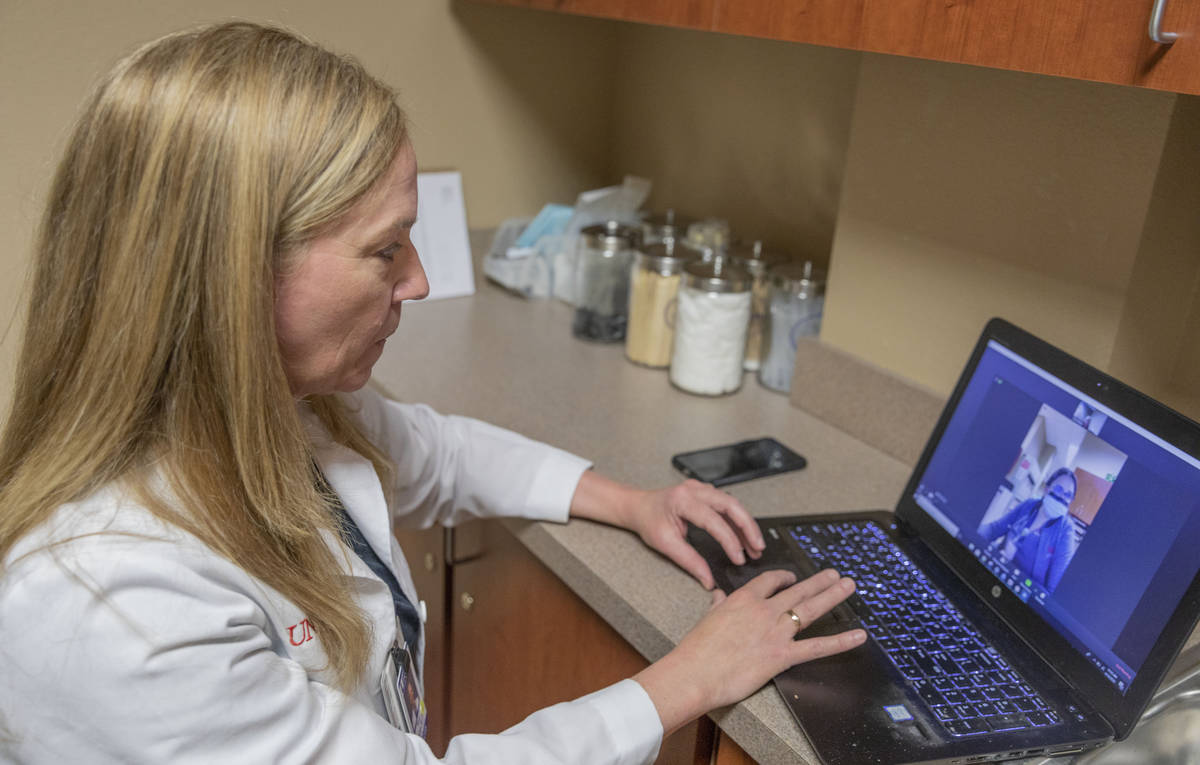 Dr. Tina Elkins, assistant professor of general otolaryngology at UNLV School of Medicine, demo ...