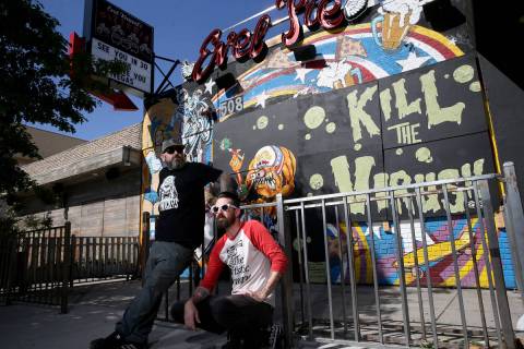 Dustin Hoots, left, and Jeff Lewis with their coronavirus mural on the boarded up windows of Ev ...
