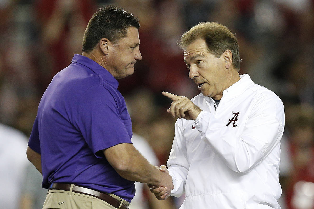 FILE - In this Nov. 4, 2017, file photo, LSU head coach Ed Orgeron, left, and Alabama head coac ...