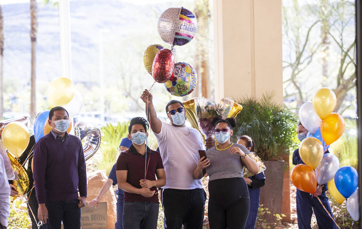 Friends, family and medical staff cheer for MountainView Hospital nurse Bessy Angue (out of fra ...