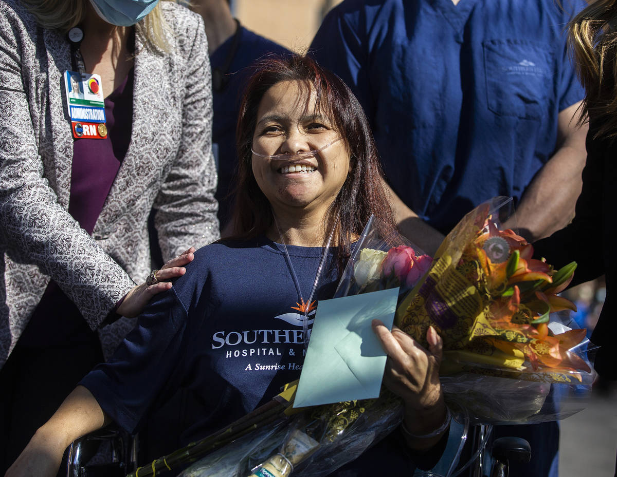 MountainView Hospital nurse Bessy Angue is greeted by friends, family and medical staff after A ...
