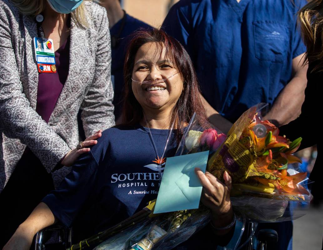 MountainView Hospital nurse Bessy Angue is greeted by friends, family and medical staff after A ...
