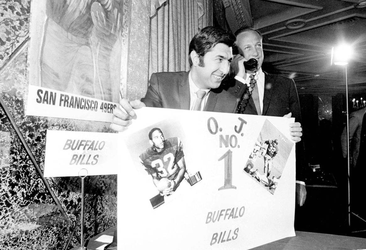 Lou Sahadi of the Buffalo Bills beams as his club made Southern California's O.J. Simpson the N ...
