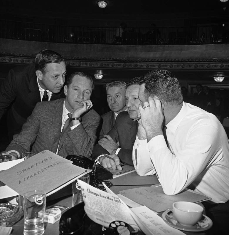 National Football League Commissioner Pete Rozelle, left, pauses to chat with serious group-off ...