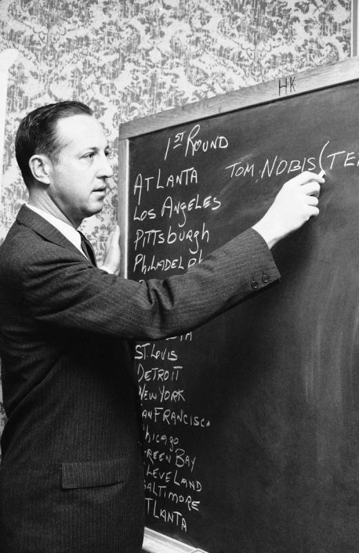 National Football League Commissioner Pete Rozelle chalks in the name of Texas linebacker Tommy ...