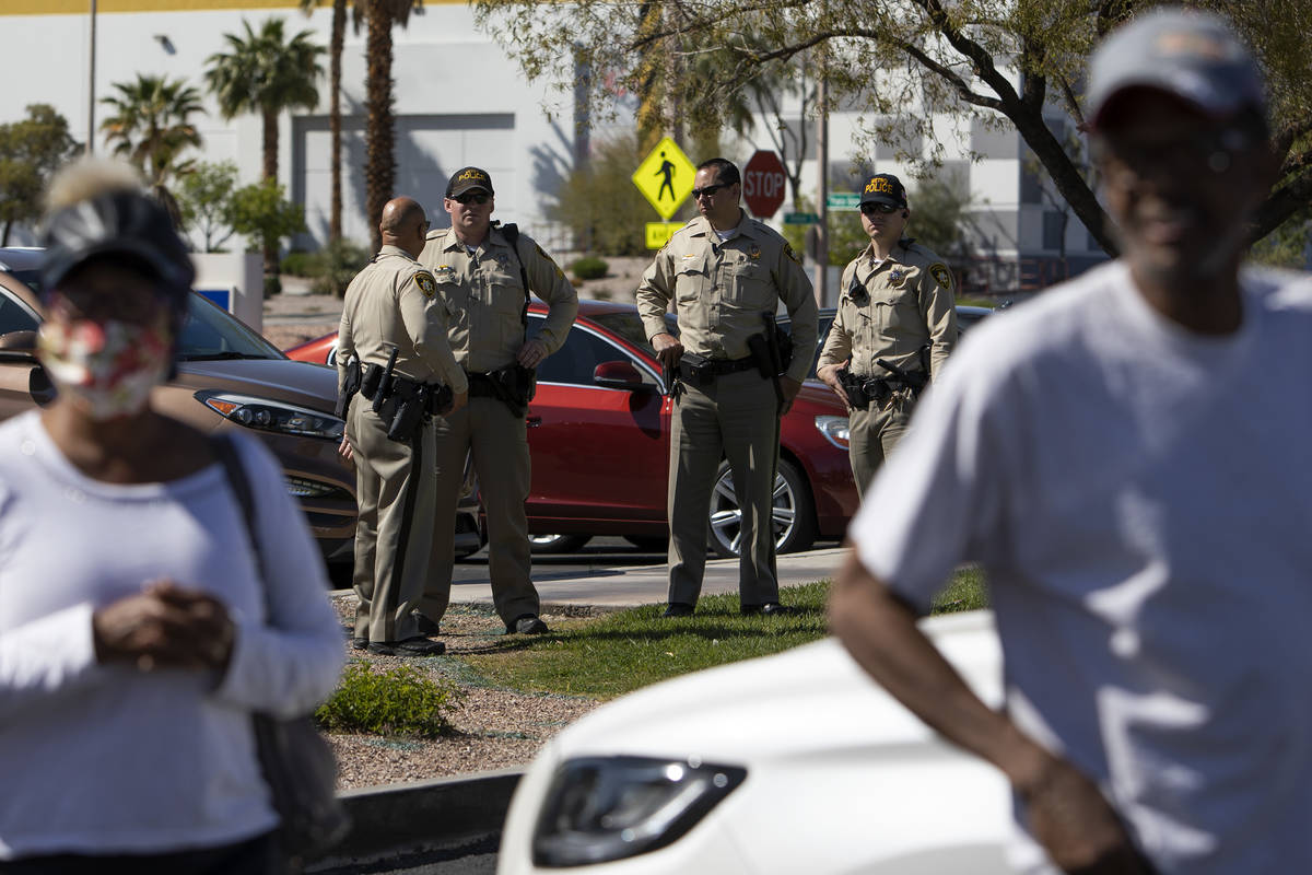 Police officers came to a drive-through COVID-19 antibody testing site to inform people waiting ...