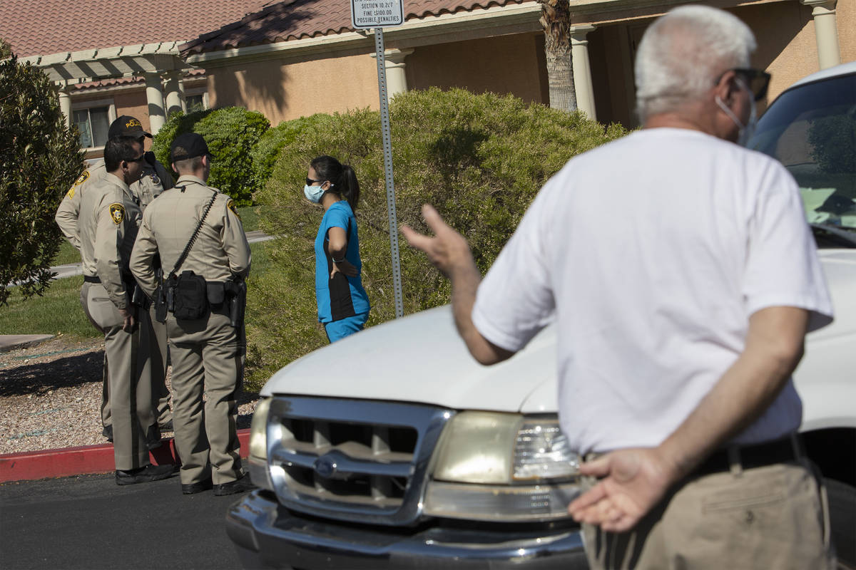 Police officers begin to inform those waiting in line for drive-through COVID-19 antibody testi ...