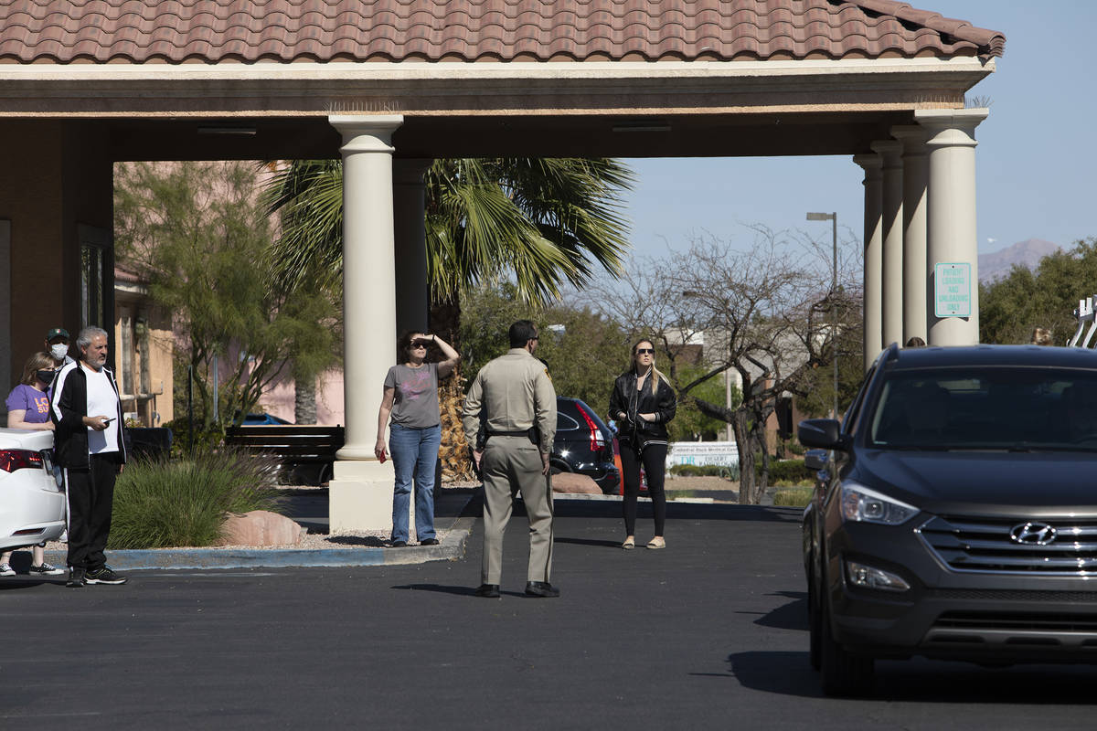 Police officers begin to inform those waiting in line for drive-through COVID-19 antibody testi ...