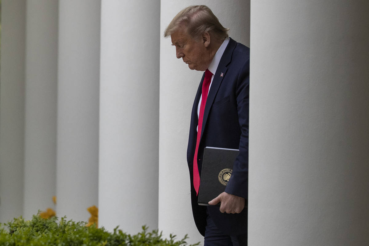 President Donald Trump arrives to speak about the coronavirus in the Rose Garden of the White H ...