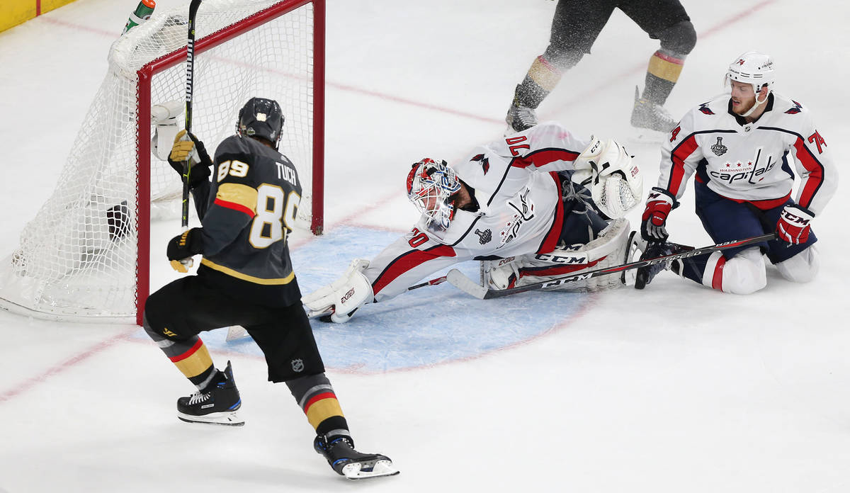 Washington Capitals goaltender Braden Holtby (70) defends a shot by Vegas Golden Knights right ...