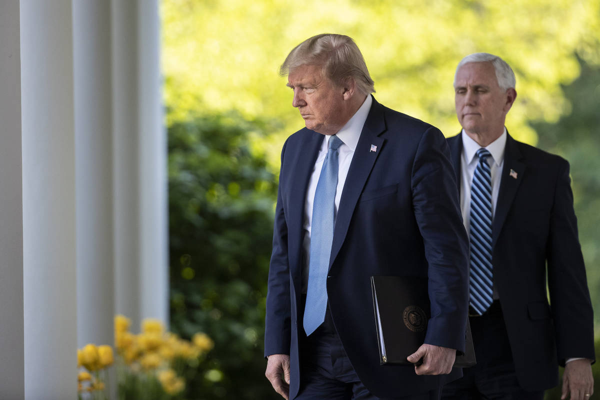 President Donald Trump, followed by Vice President Mike Pence, walks on the Colonnade to speak ...