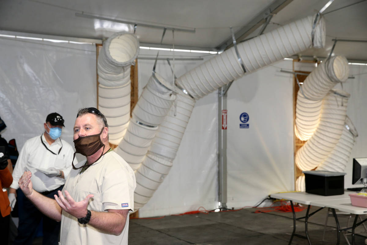 Medical Director Dr. Marc Ogriofa talks to the news media at the intake tent at the Cashman Iso ...