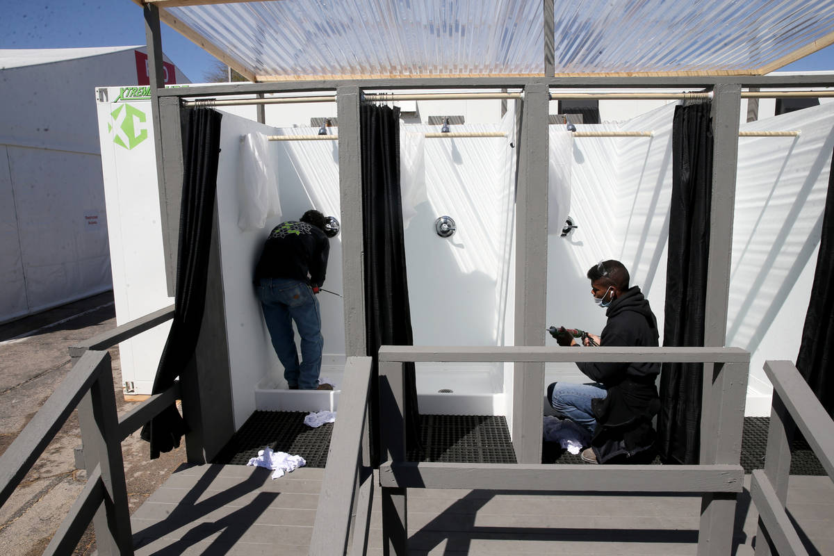 Workers prepare showers at the Cashman Isolation-Quarantine Complex in Las Vegas Monday, April ...