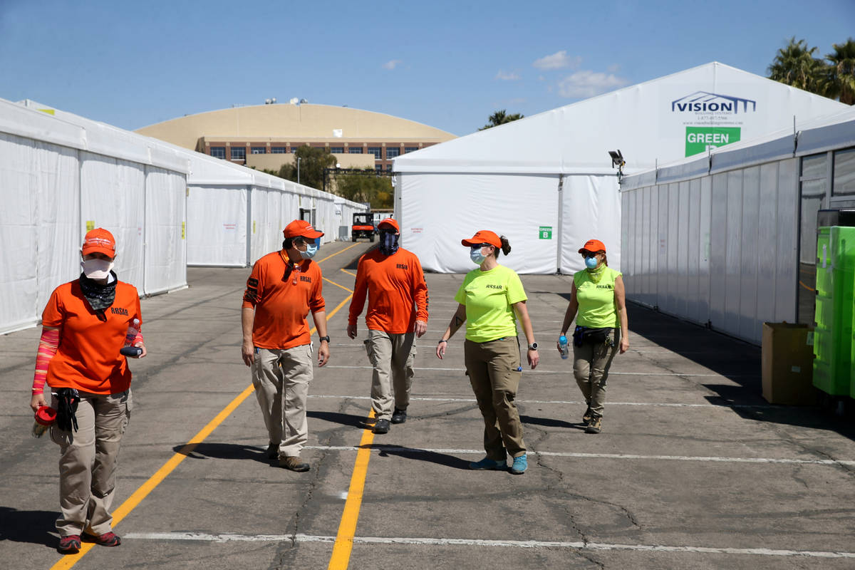 Volunteers with Red Rock Search and Rescue help set up the Cashman Isolation-Quarantine Complex ...