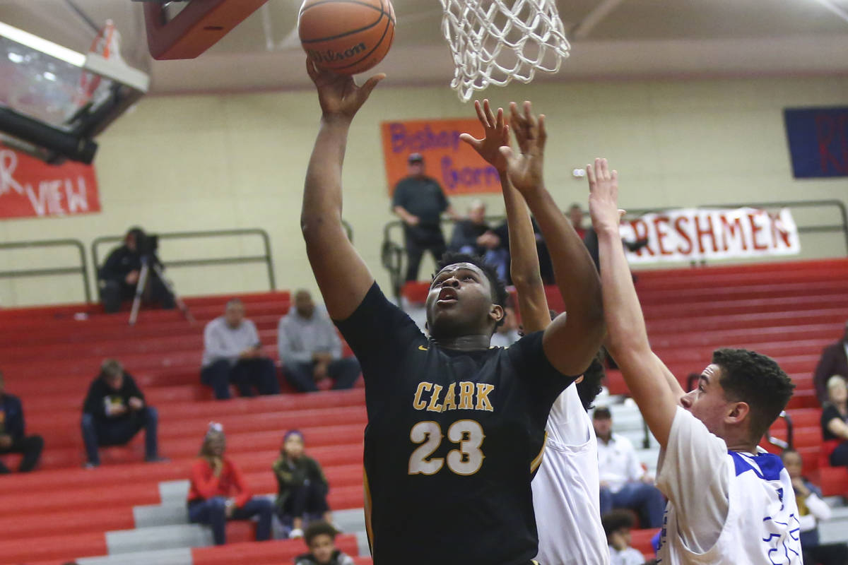 Clark's Antwon Jackson (23) shoots past Desert Pines' Jamir Stephens (33) during the second hal ...