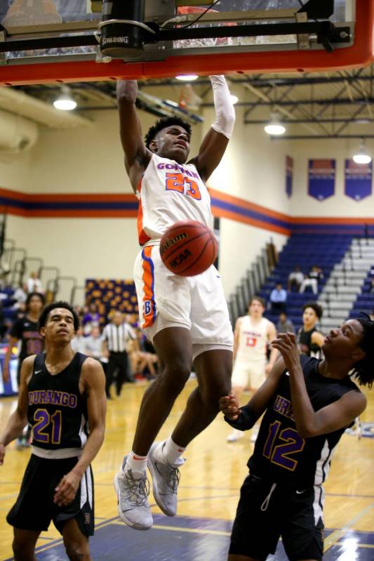 Bishop Gorman forward Mwani Wilkinson (23) dunks between Durango guards Anthony Hunter (21) and ...