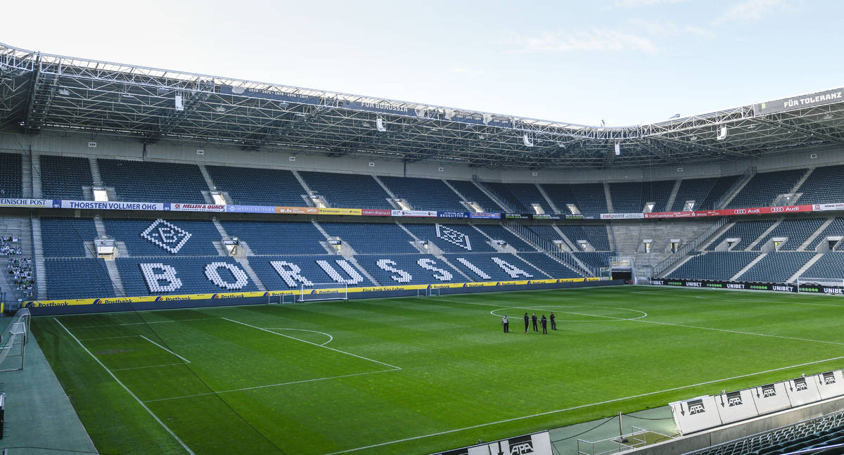 Only a few workers stand on the pitch of the empty stadium of German Bundesliga soccer club Bor ...