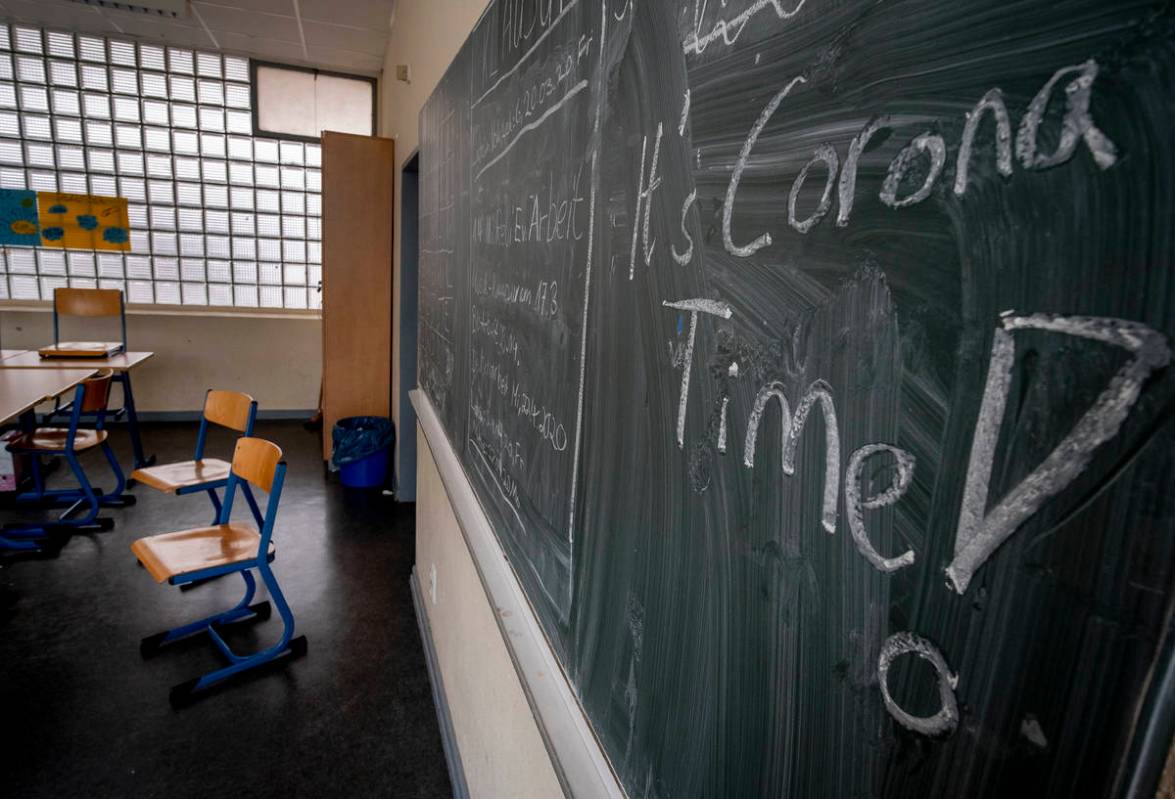 FILE -- In this Friday, March 13, 2020 photo a slogan on a chalkboard reads 'It's Corona Time' ...