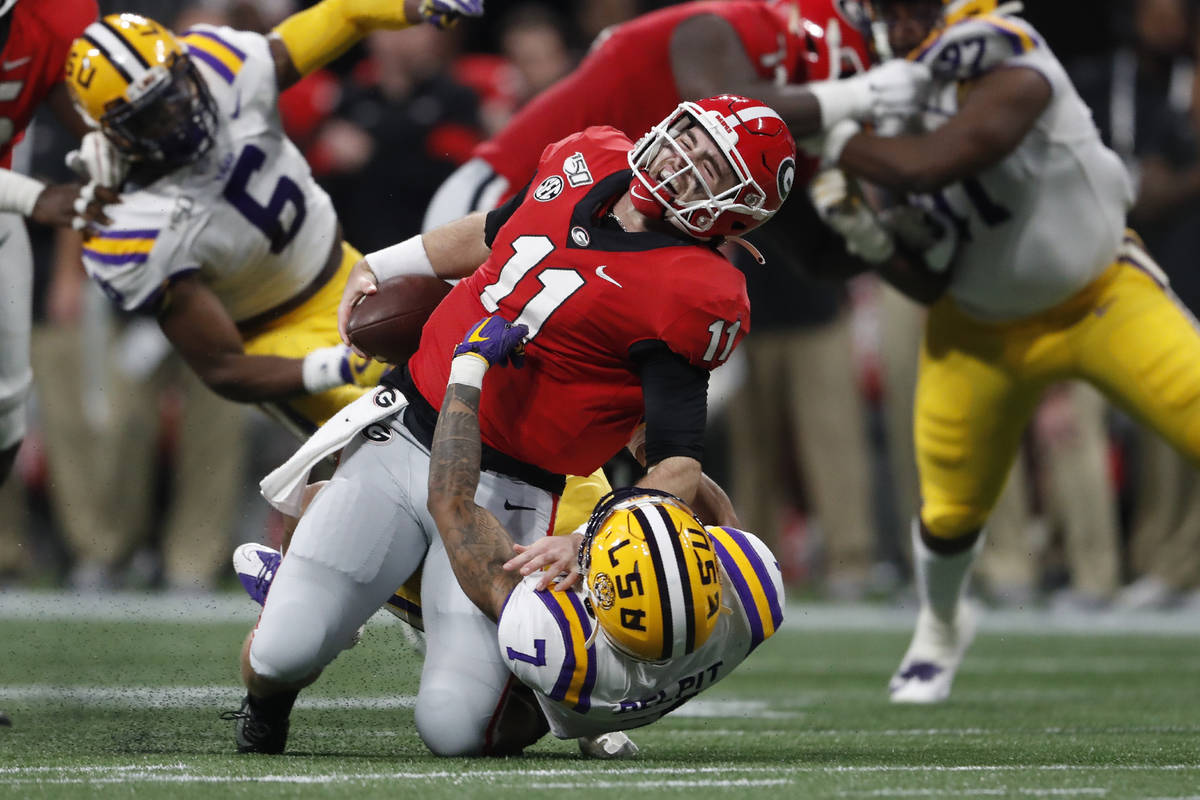 LSU safety Grant Delpit (7) sacks Georgia quarterback Jake Fromm (11) during the first half of ...