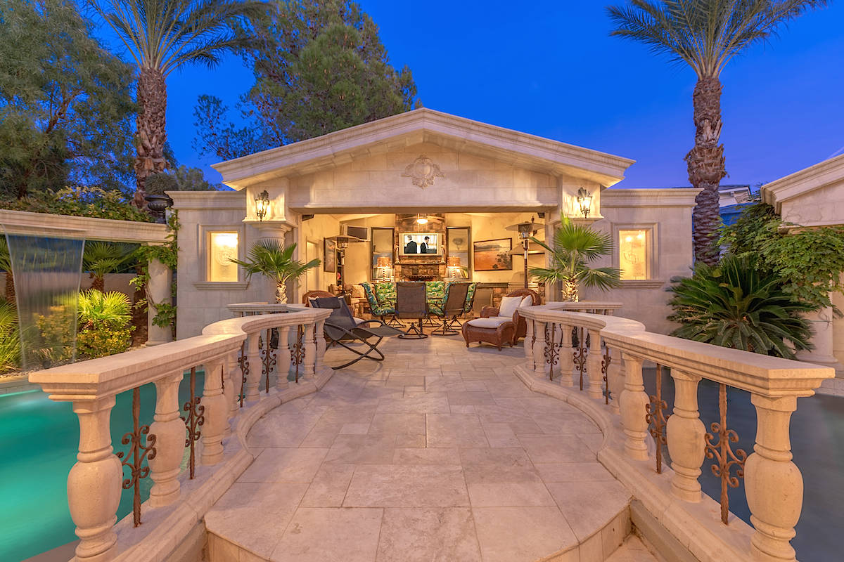 The two pools in the backyard are divided by a stone cabana. (Tom Love Group)