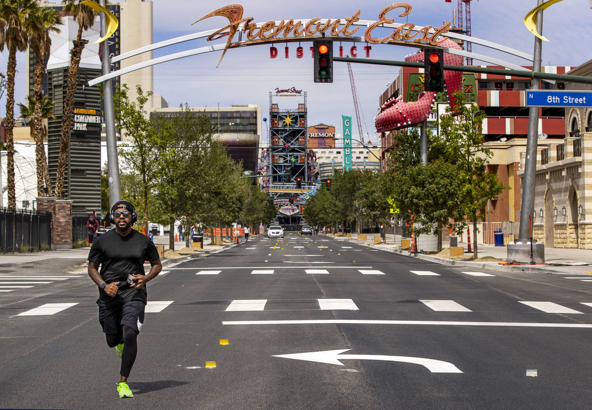 Kendrick Mills runs along an empty Fremont Street in Downtown Las Vegas during the novel corona ...