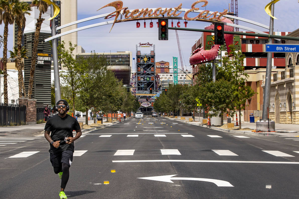 Kendrick Mills runs along an empty Fremont Street in Downtown Las Vegas during the novel corona ...