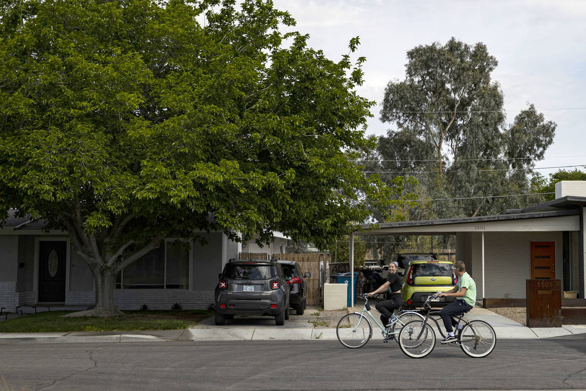 People ride their bikes in the historic Huntridge neighborhood in Las Vegas on Saturday, April ...