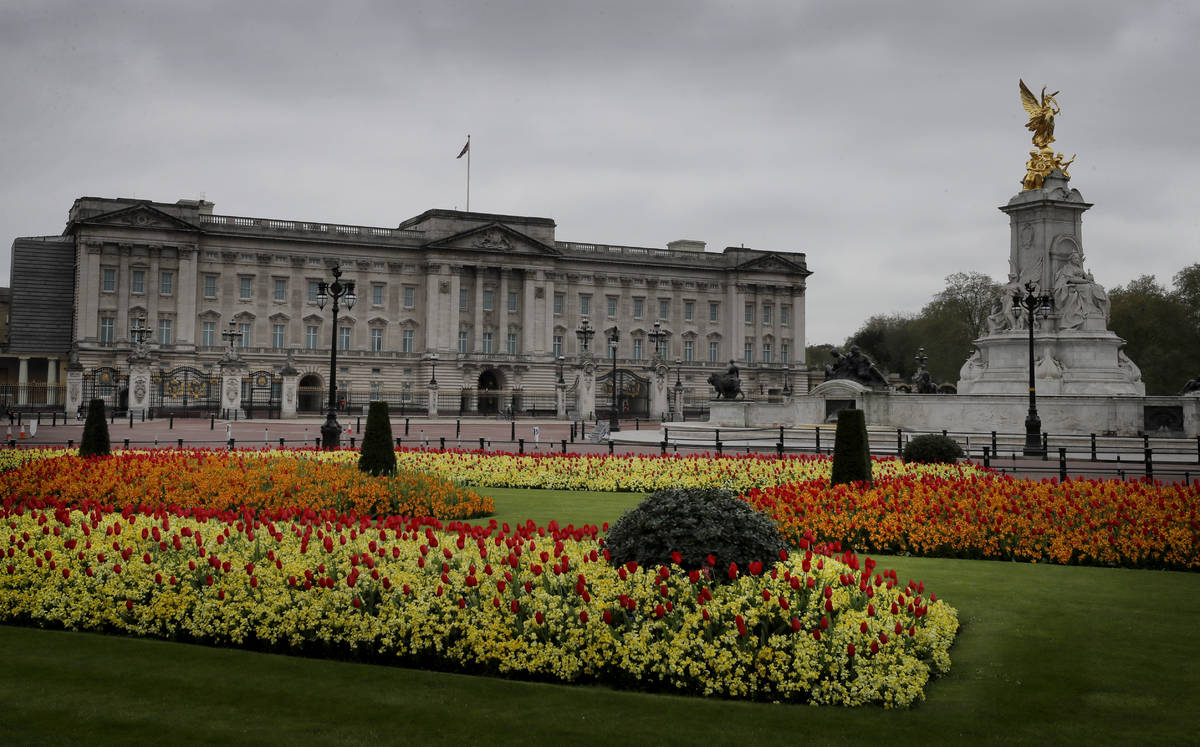 A display of tulips and wallflowers near a deserted Buckingham Palace, as the country continues ...