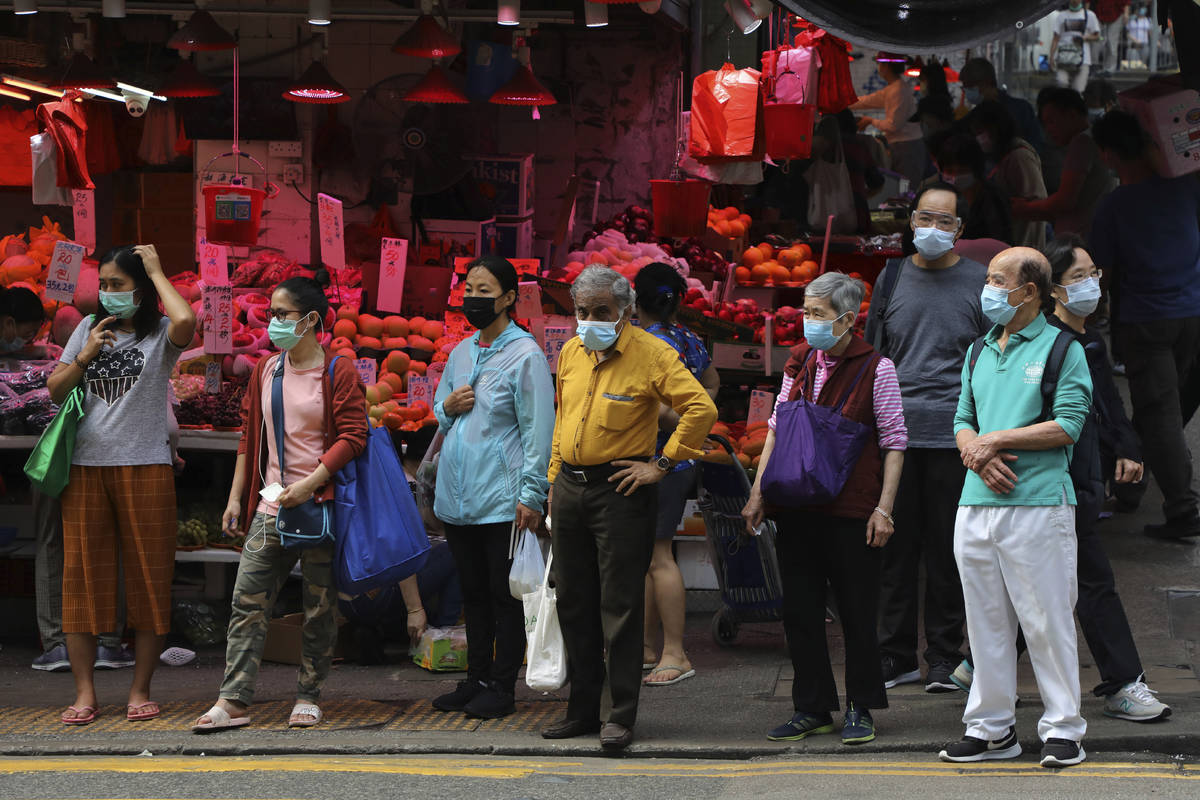 People wearing face masks to help protect themselves from contracting the coronavirus COVID-19 ...