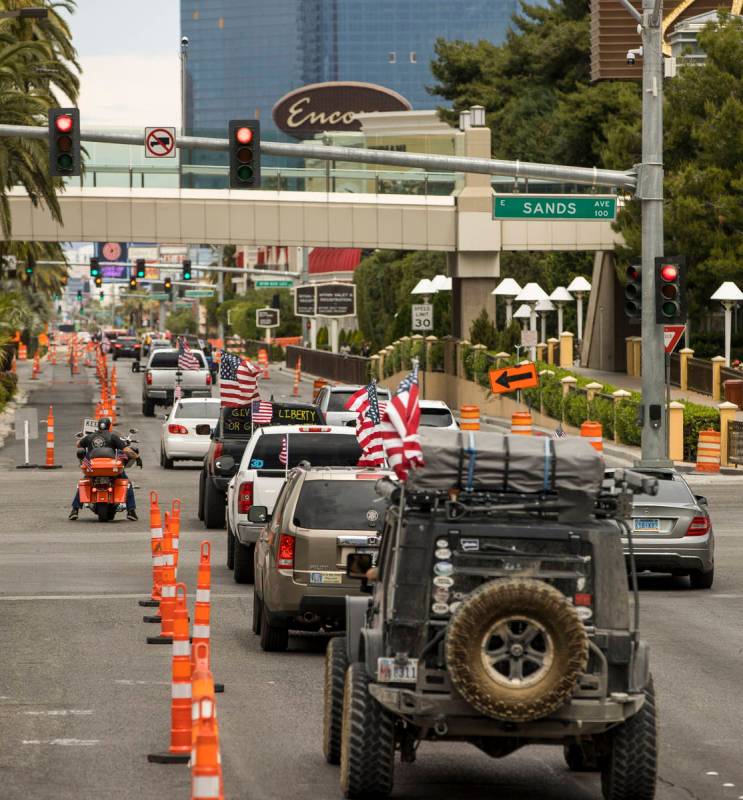 A caravan drives up the Las Vegas Strip to the Reopen Nevada protest against Gov. Sisolak to op ...