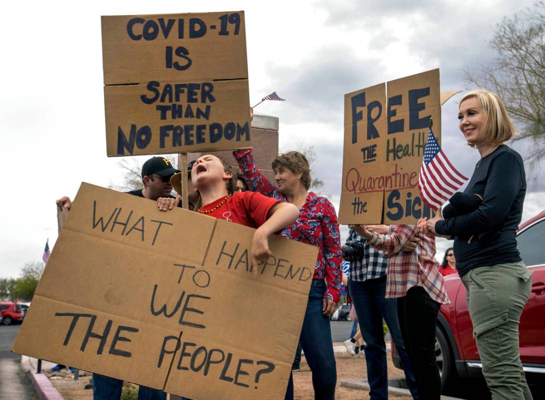 Protester Adaira McKnight, 9, yells out the words to her sign as others stream in during the Re ...