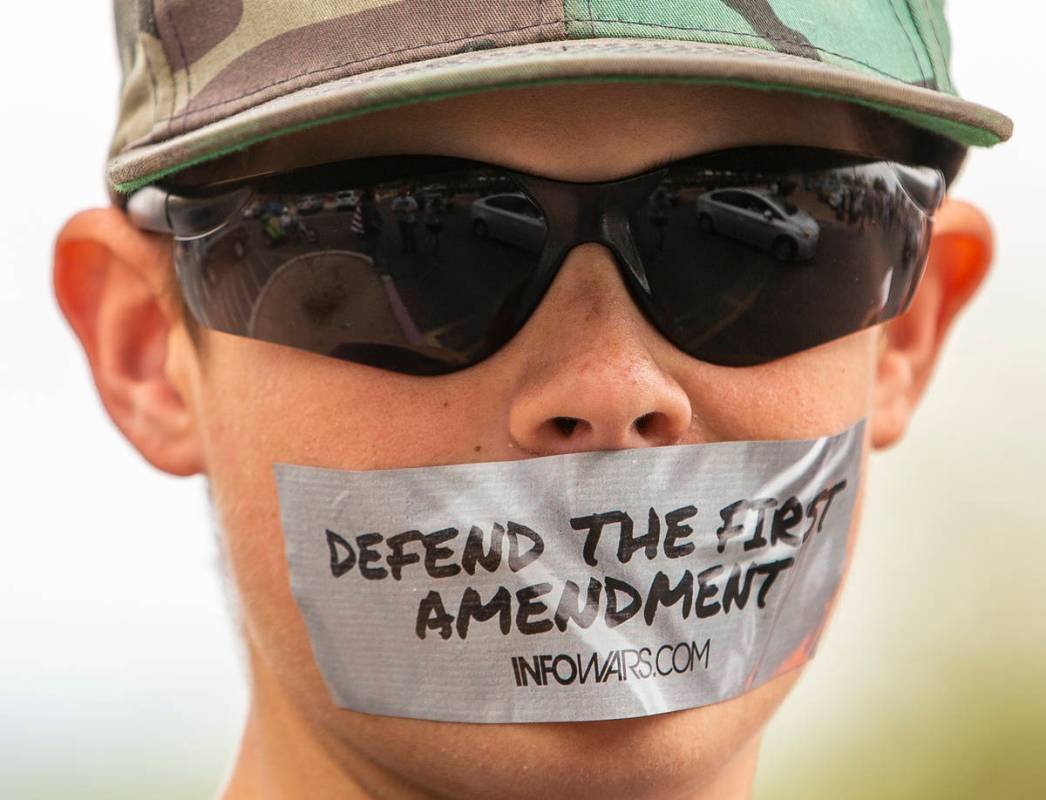 A silent protester makes his point at the Grant Sawyer State Office Building organized by Reope ...