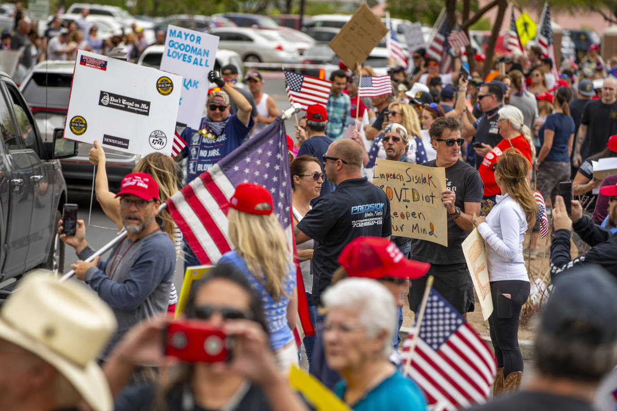 Protesters chant while gathered at the Grant Sawyer State Office Building organized by Reopen N ...