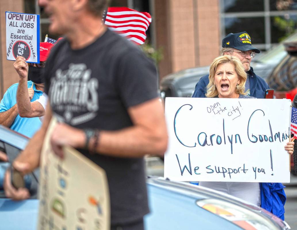 Sue Thiel, right, takes part in a protest outside the Grant Sawyer State Office Building organi ...