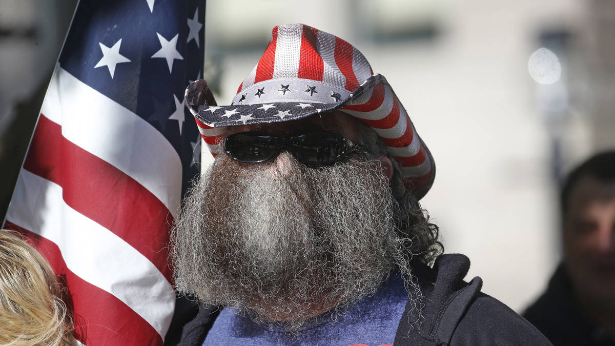 A man looks on during the Utah Business Revival rally, calling for Utah's economy to be reopene ...