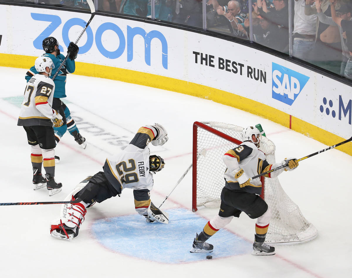 Knights goaltender Marc-Andre Fleury (29) gets turned around after Sharks right wing Barclay Go ...