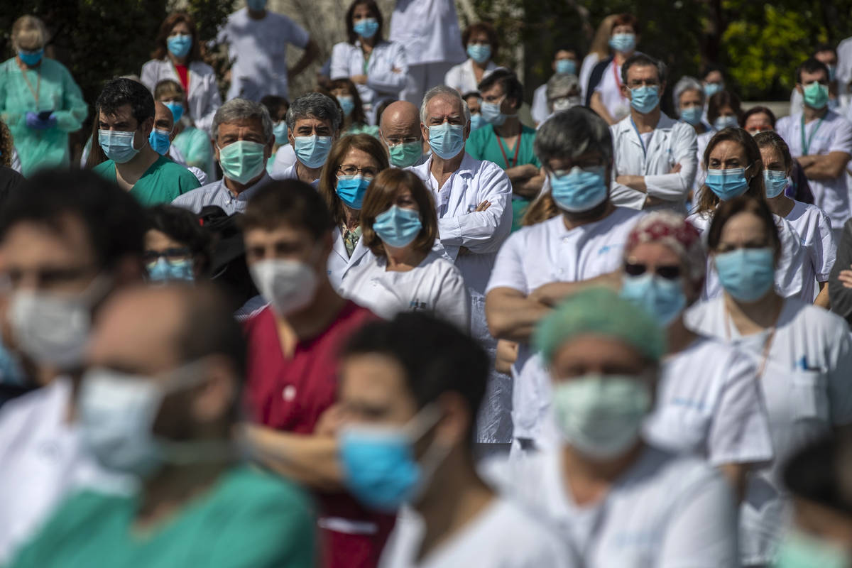 Health workers hold a minute of silence to remember Joaquin Diaz, the hospital's chief of surge ...