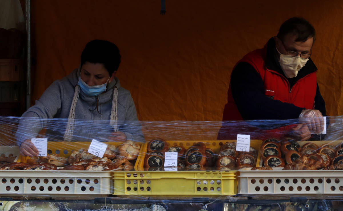 Street vendors prepare their stand as the farmers markets open in Prague, Czech Republic, Monda ...