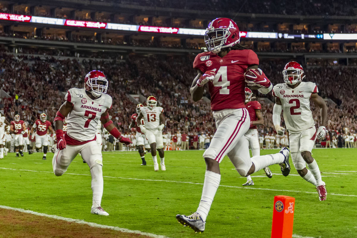 FILE - In this Oct. 26, 2019, file photo, Alabama wide receiver Jerry Jeudy (4) scores on a pas ...