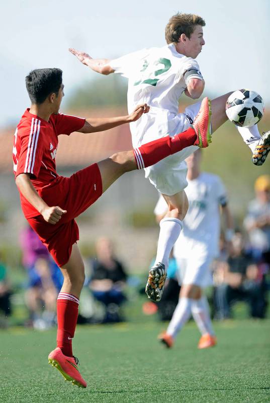 Palo Verde defender Griffin Mallas (12) challenges Valley midfielder Alejandro Parra, left, dur ...