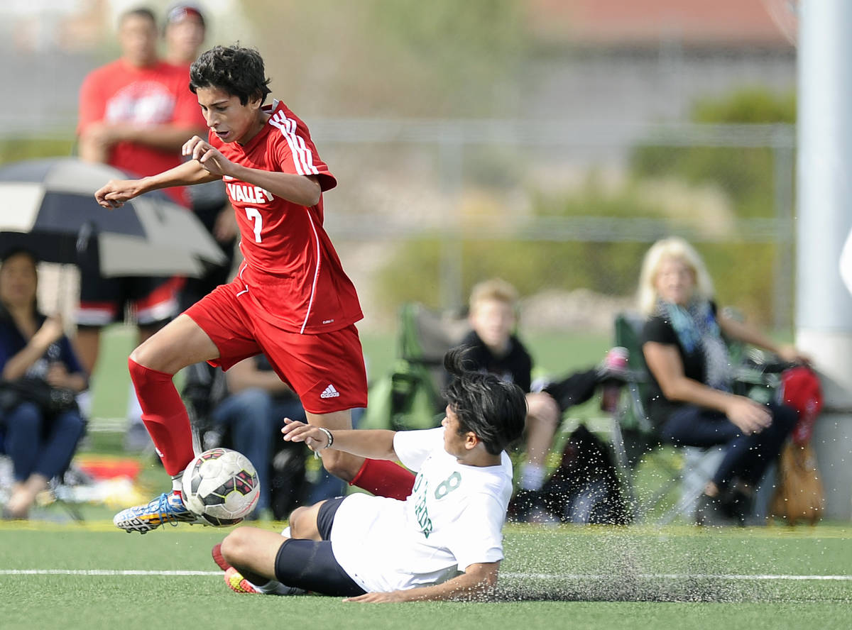 Palo Verde defender Ben DeLeon (8) slide tackles Valley midfielder Sebastian Salcedo (7) during ...