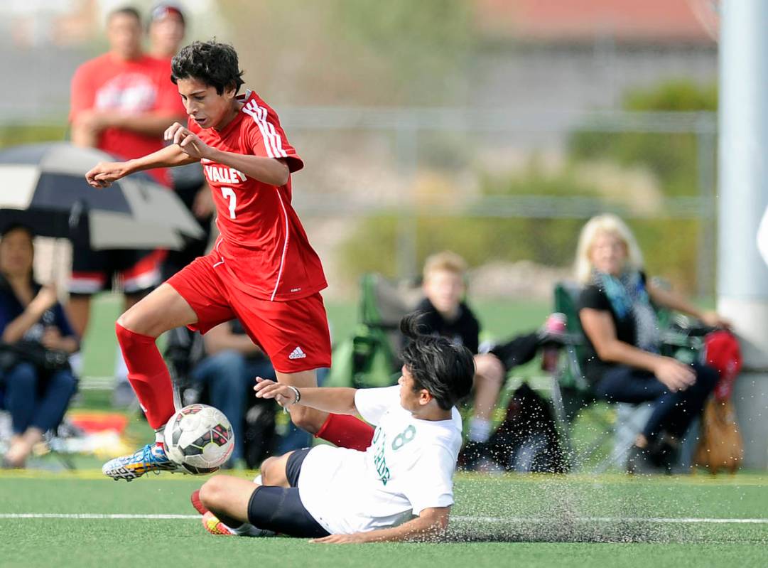 Palo Verde defender Ben DeLeon (8) slide tackles Valley midfielder Sebastian Salcedo (7) during ...