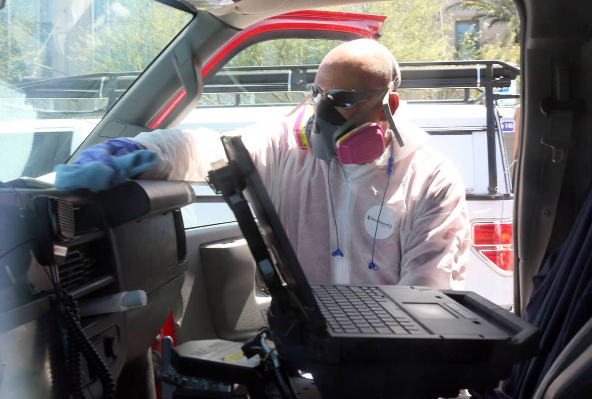 Bill Meeks, owner of Summit Restoration, disinfects a Las Vegas Fire Department Paramedic truck ...